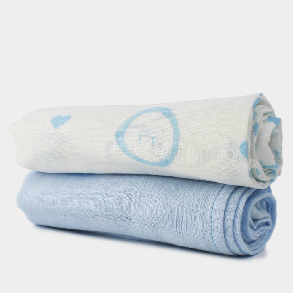 Two large 60x60cm soft cotton muslin cloths, one blue solid colour and one with our blue walrus character and signature hearts pattern. Newborn essential ideal for burping, dribbling, and comforting.