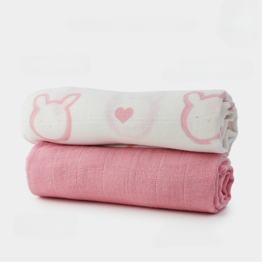 Two large 60x60cm soft cotton muslin cloths, one pink solid colour and one with our pink bunny character and signature hearts pattern. Newborn essential ideal for burping, dribbling, and comforting.