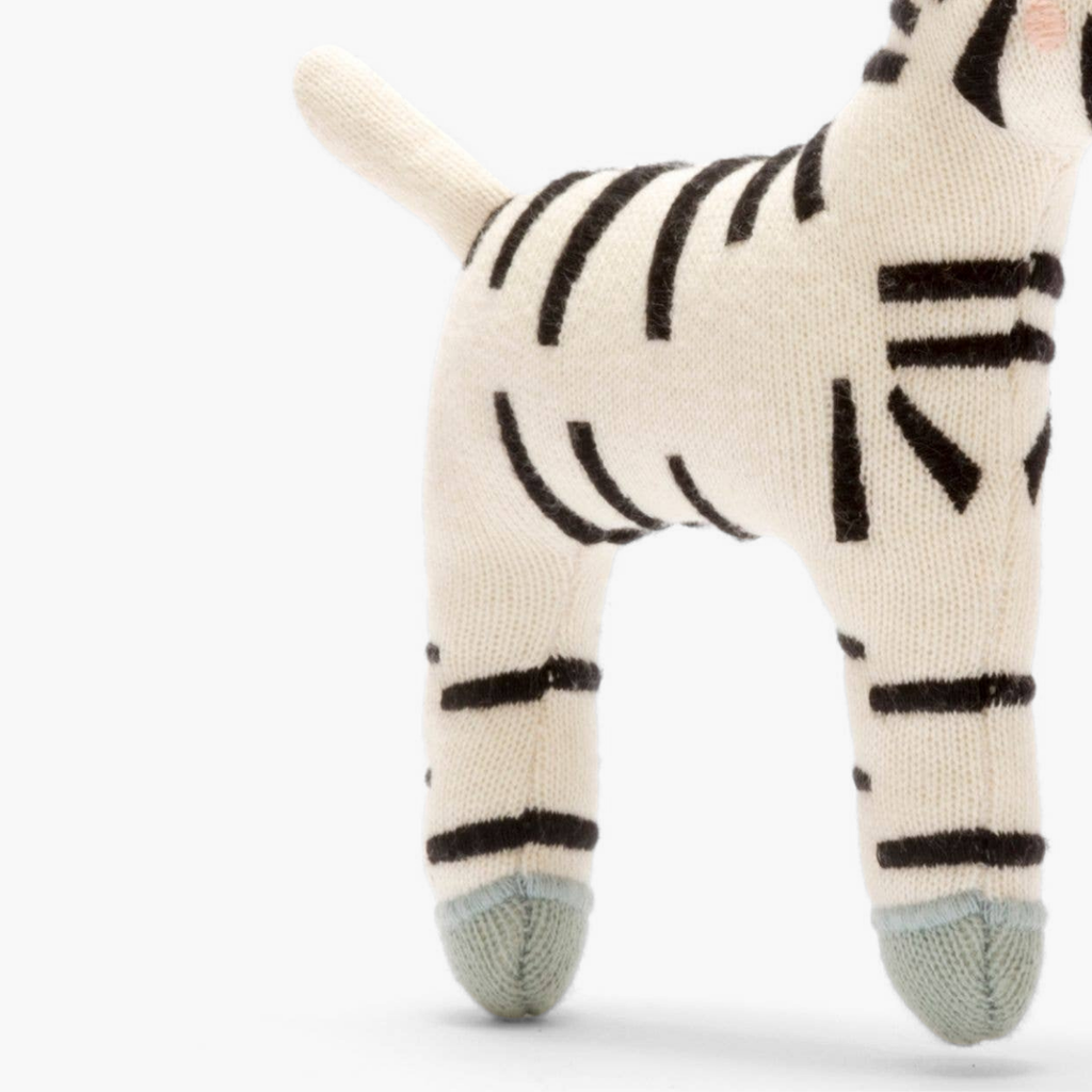 Knitted zebra toy on a white background