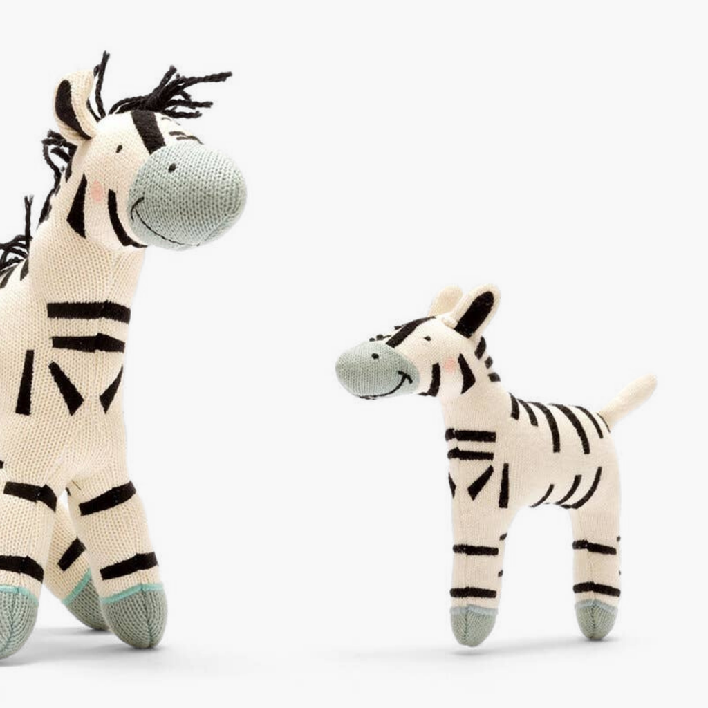 Two zebra plush toys on a white background