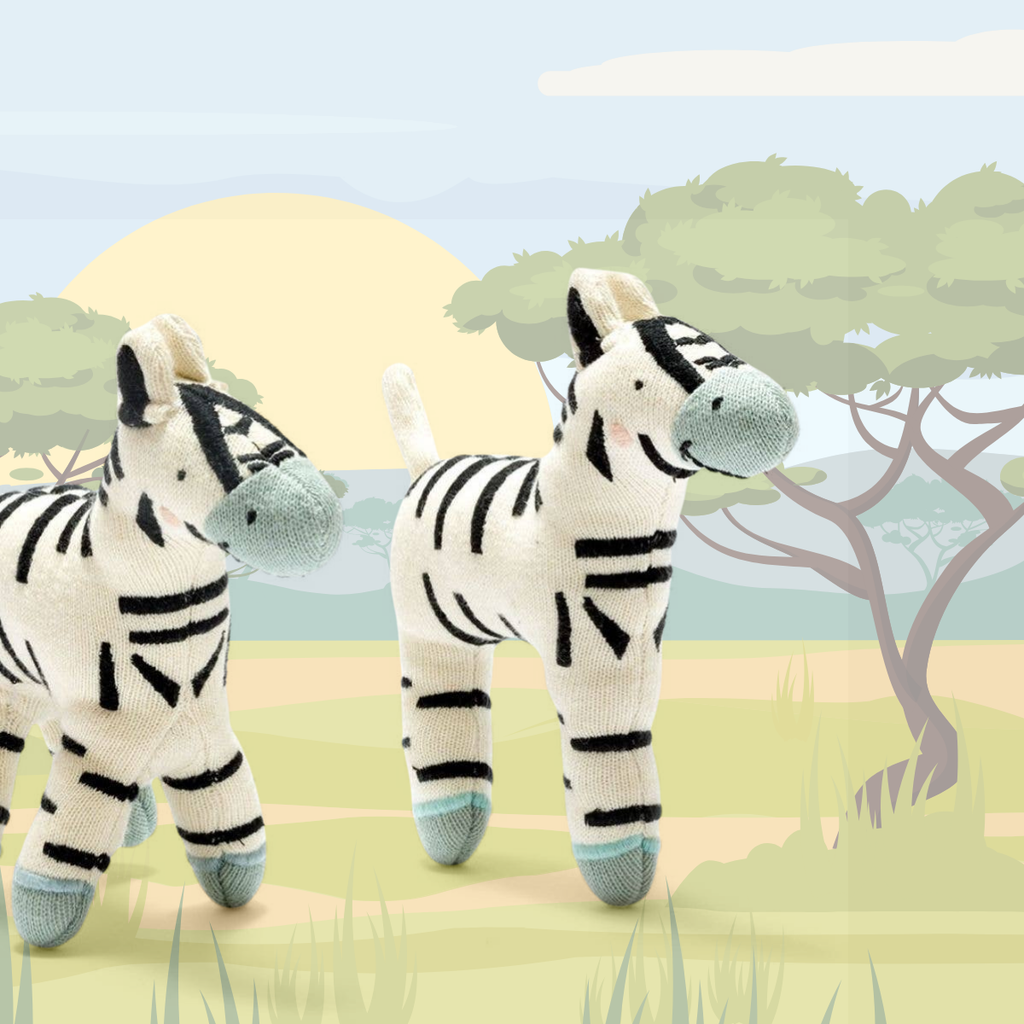 Two plush zebra toys with a cartoonish landscape background